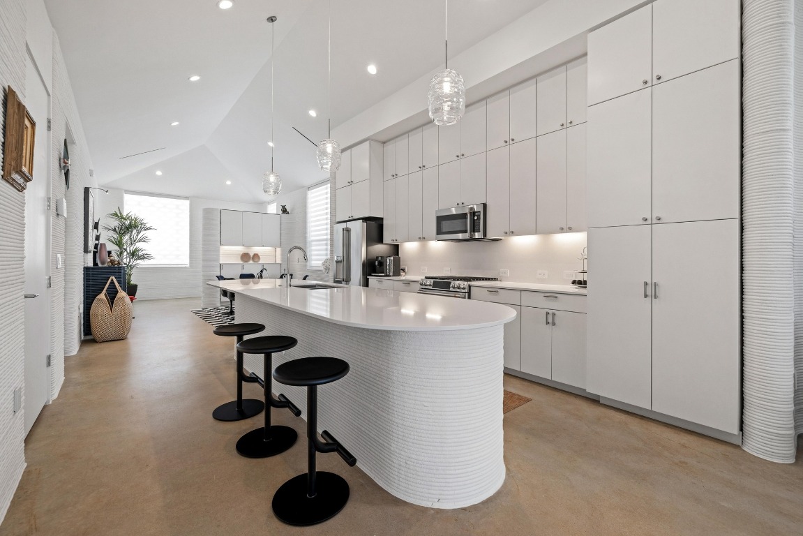 213 Lone Ranger Trail Georgetown, TX 78628 - Photo 10 of 26 a kitchen with refrigerator and chairs
