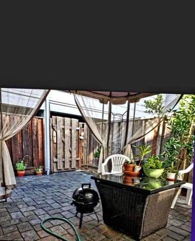 a view of a chairs and table in patio