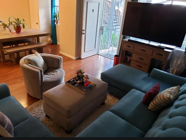 a living room with furniture rug and wooden floor