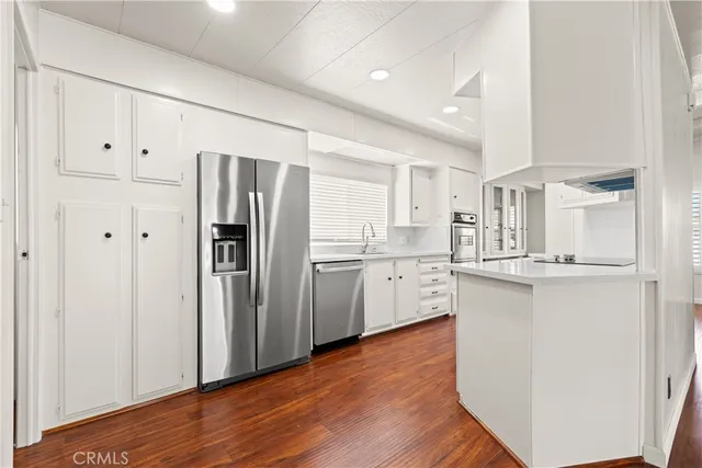 a kitchen with stainless steel appliances a refrigerator sink and cabinets