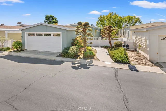 a view of a house with a yard and a garage