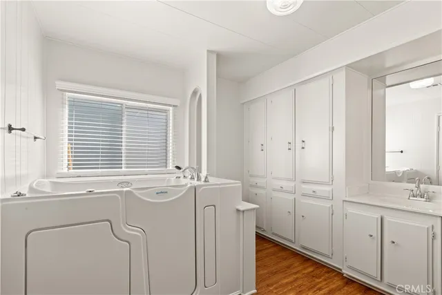 a bathroom with a sink a vanity and a window