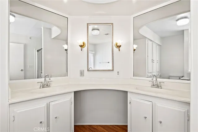a bathroom with a sink double vanity and a mirror