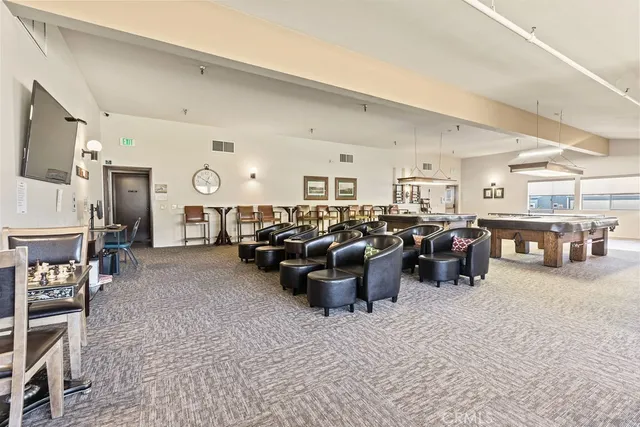 a living room with lots of furniture and a large window