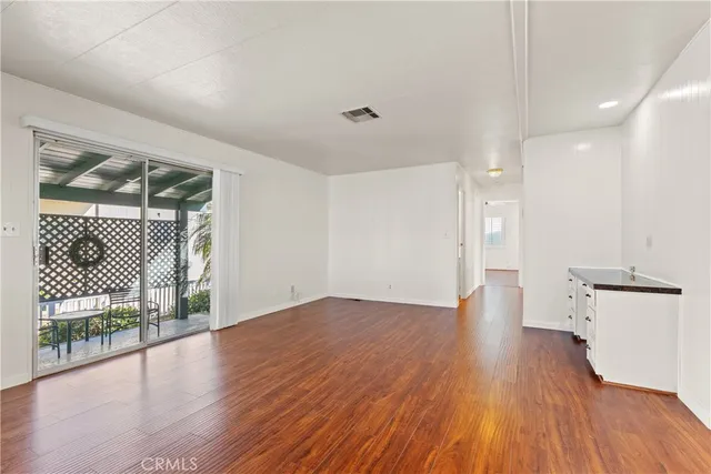 a view of a hallway with wooden floor and a floor to ceiling window