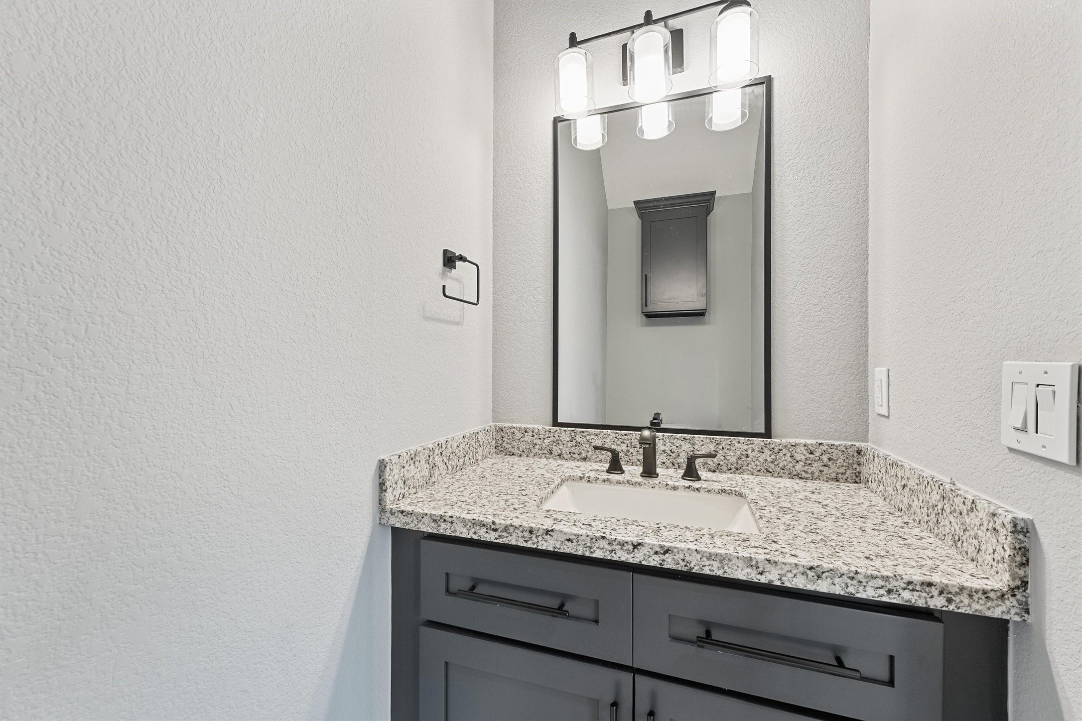 7704 Sealey Street Houston, TX 77088 - Photo 6 of 15 a bathroom with a granite countertop sink and a mirror