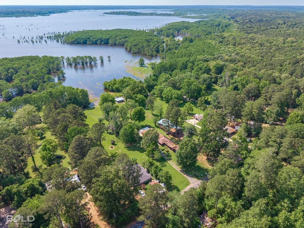 225 Marie Road Ringgold, LA 71068 - Photo 39 of 40 Expansive wooded acreage featuring a large lake, multiple residential structures, and extensive tree cover
