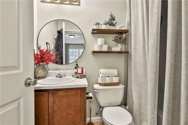 a bathroom with a toilet a sink and a mirror