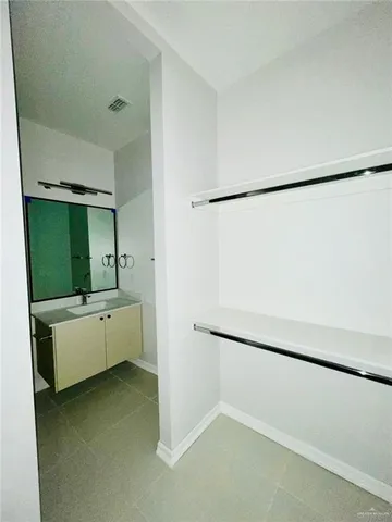 a room with a refrigerator and a ceiling fan