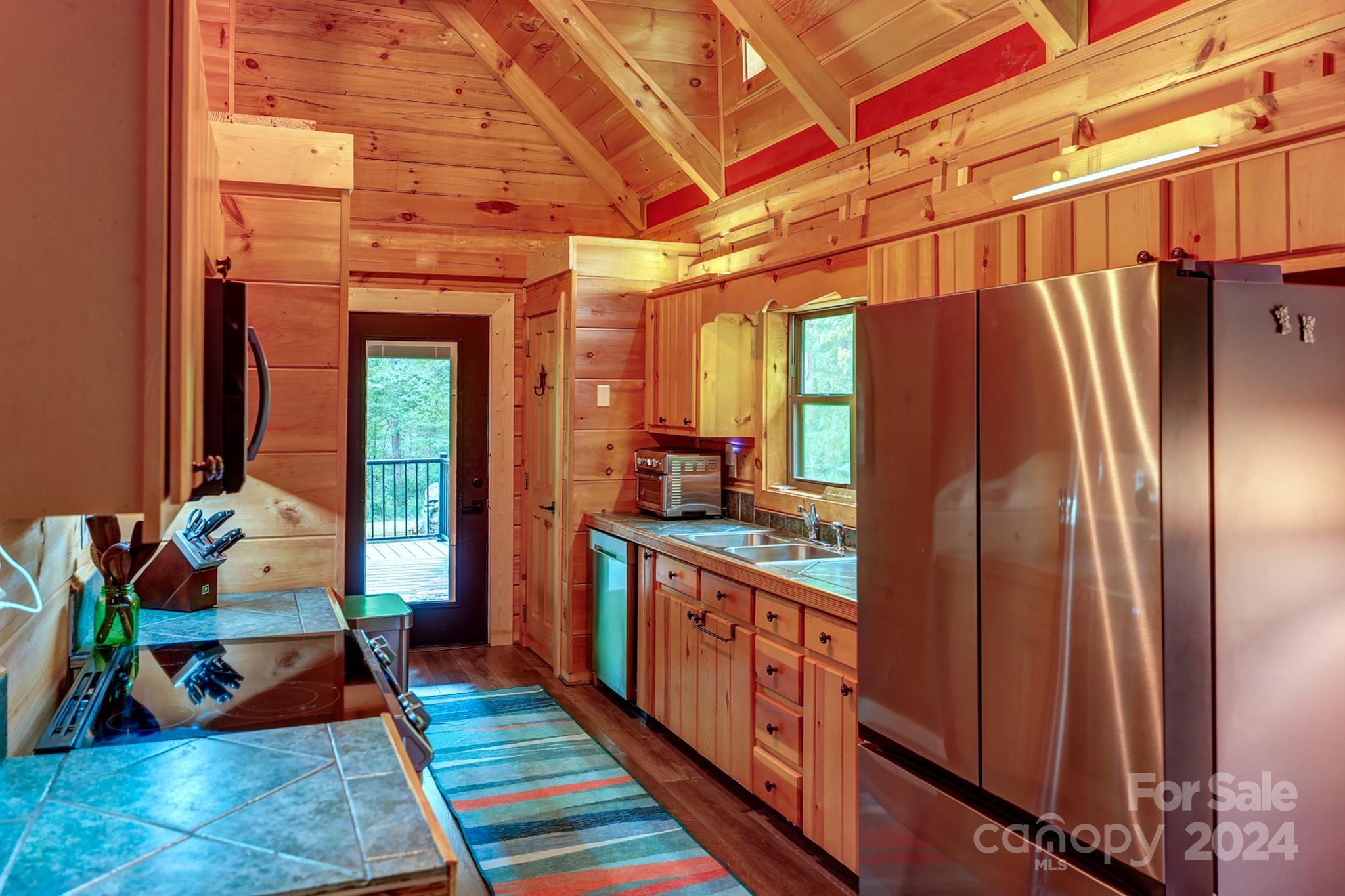 997 Proctor Road Lake Lure, NC 28746 - Photo 11 of 43 a kitchen with stainless steel appliances granite countertop a refrigerator and a stove