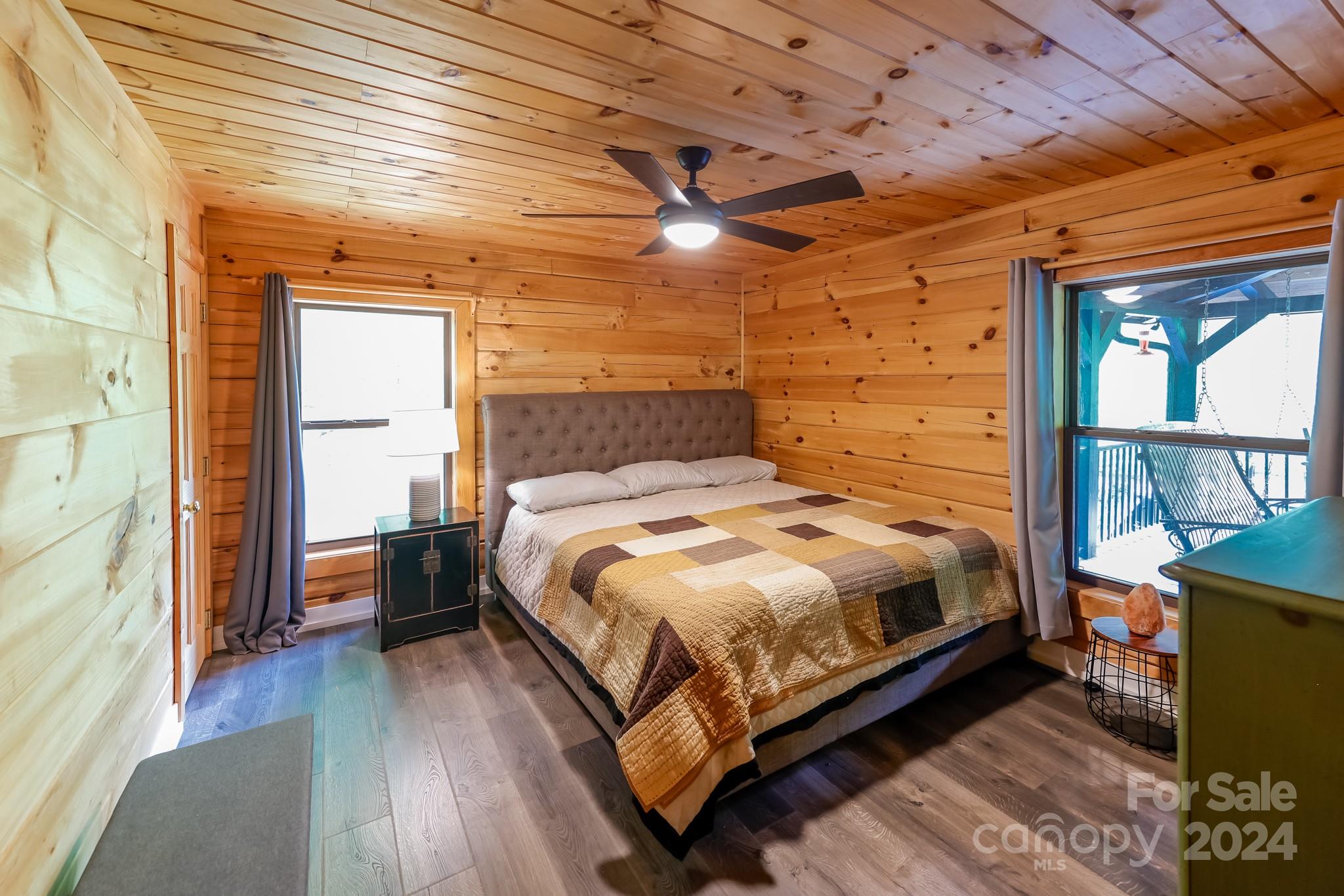 997 Proctor Road Lake Lure, NC 28746 - Photo 14 of 43 a bedroom with a bed next to a large window