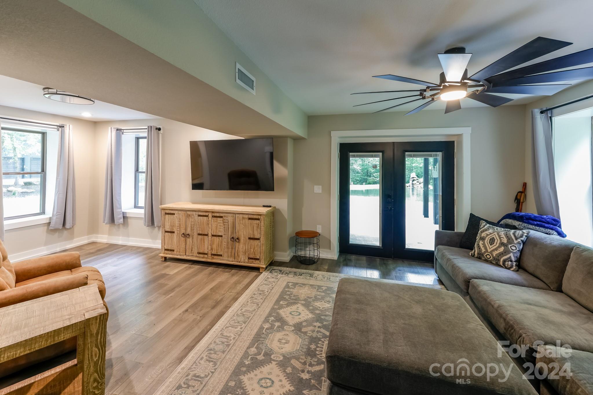 997 Proctor Road Lake Lure, NC 28746 - Photo 16 of 43 a living room with furniture and a flat screen tv