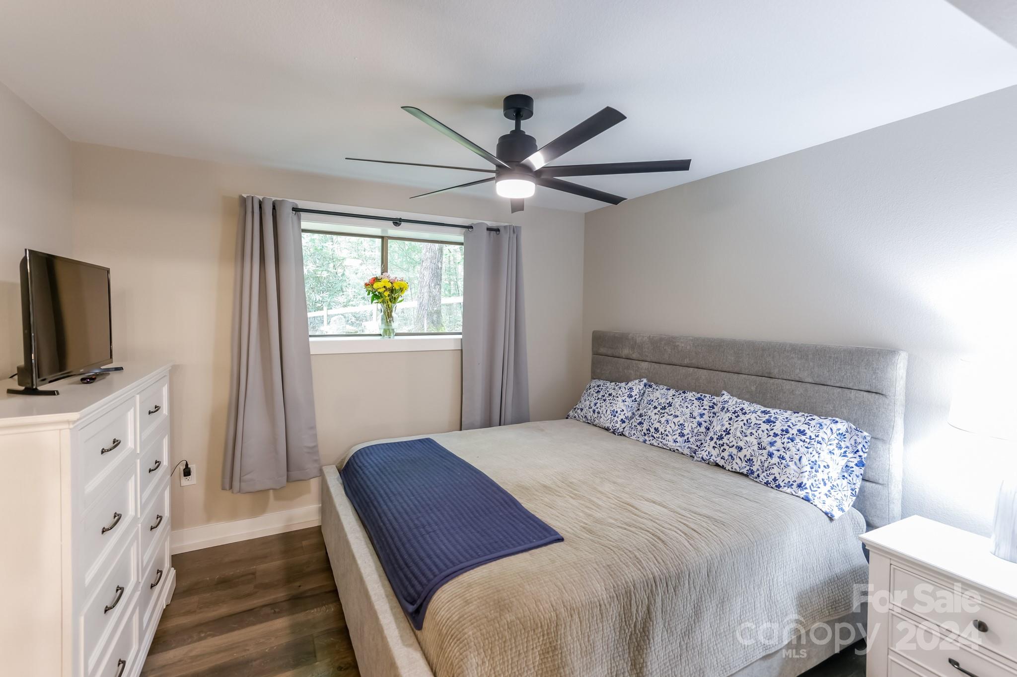 997 Proctor Road Lake Lure, NC 28746 - Photo 17 of 43 a bedroom with a bed and a flat screen tv