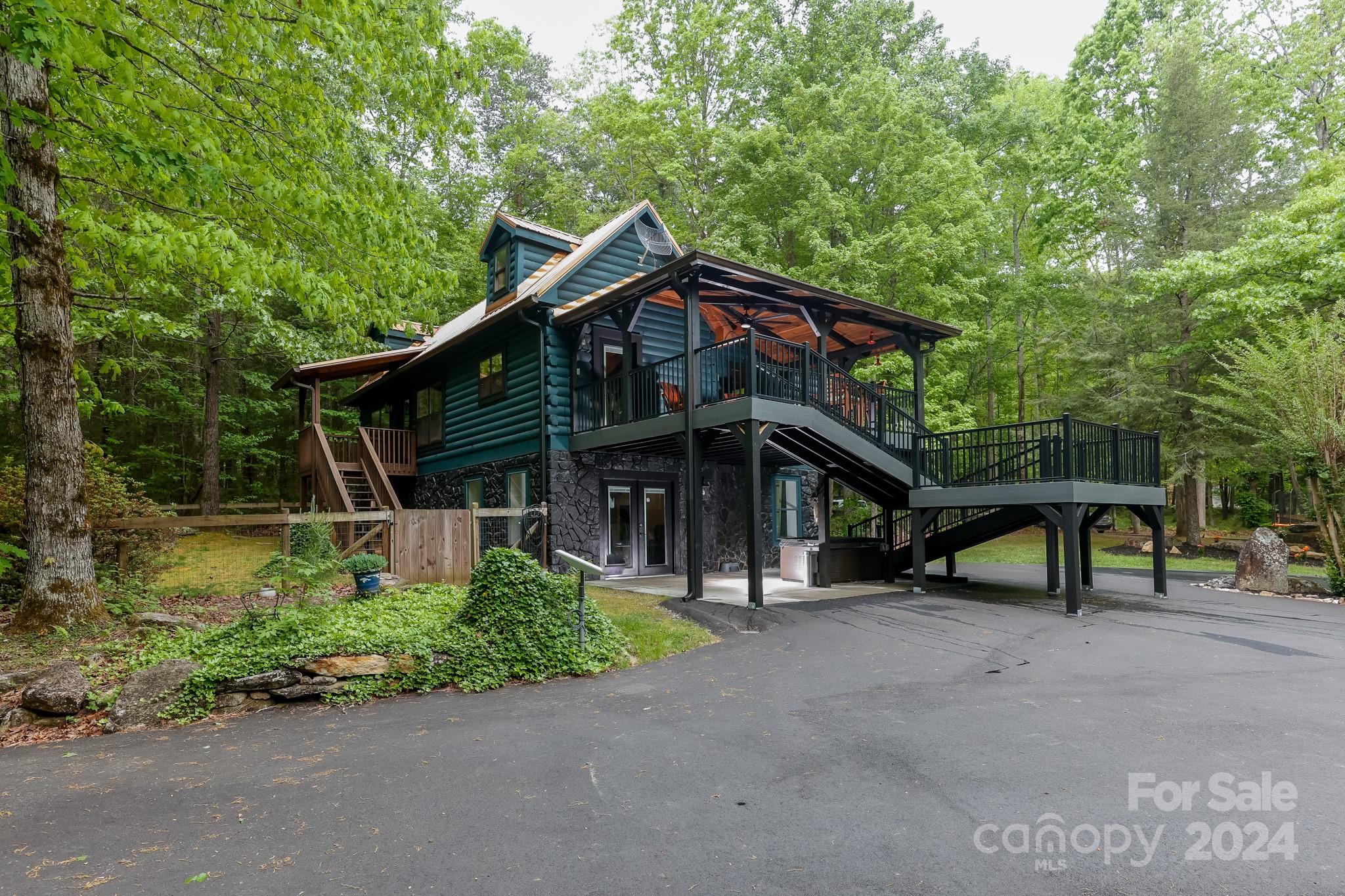 997 Proctor Road Lake Lure, NC 28746 - Photo 2 of 43 a front view of a house with garden