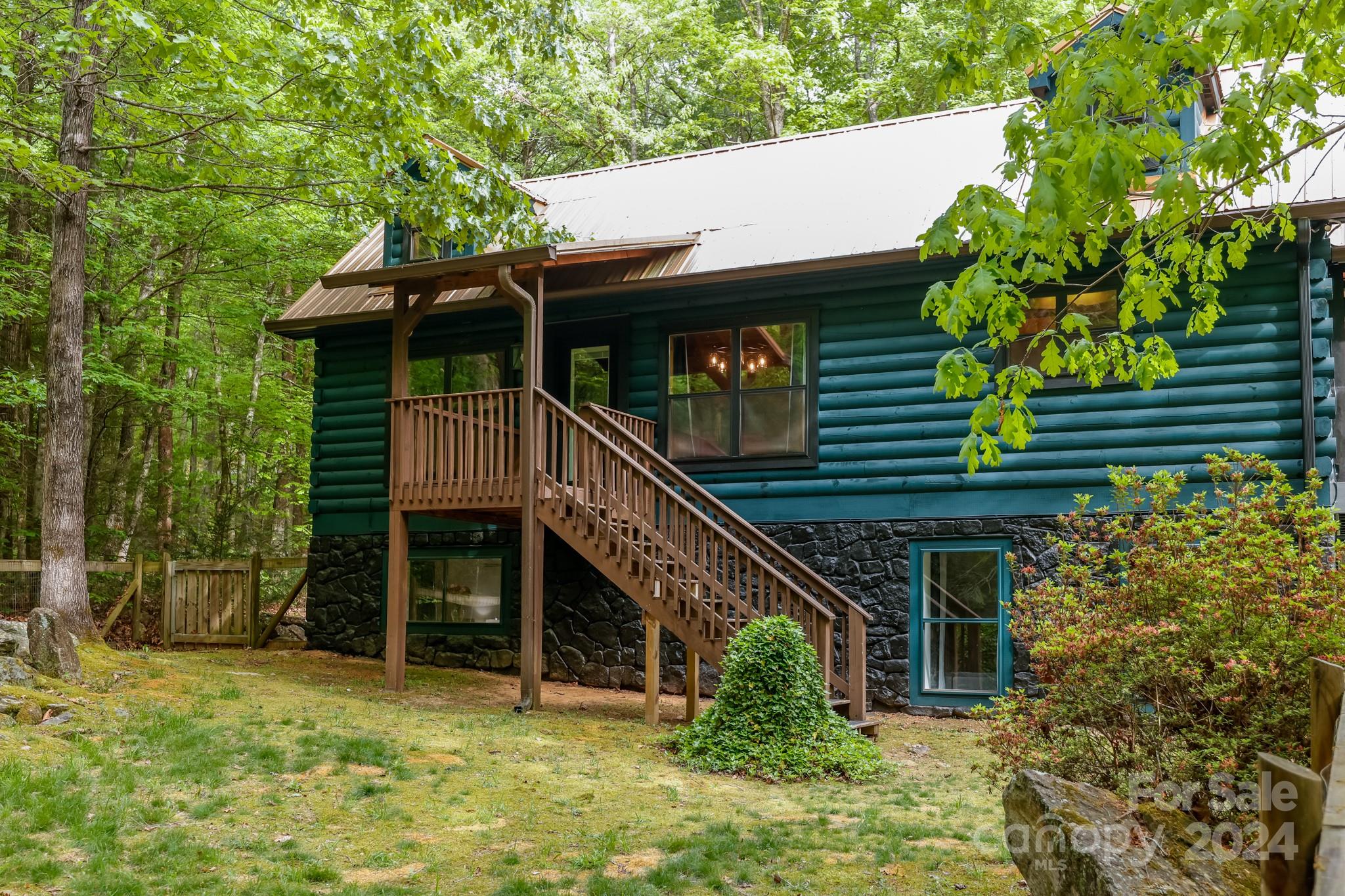 997 Proctor Road Lake Lure, NC 28746 - Photo 4 of 43 a house with trees in front of it