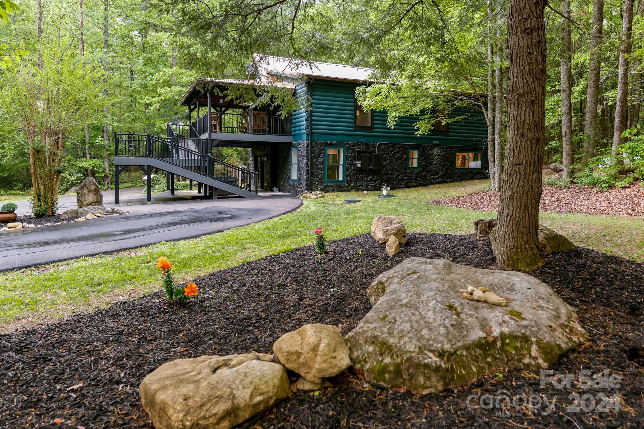 997 Proctor Road Lake Lure, NC 28746 - Photo 42 of 43 a view of a house with backyard and sitting area
