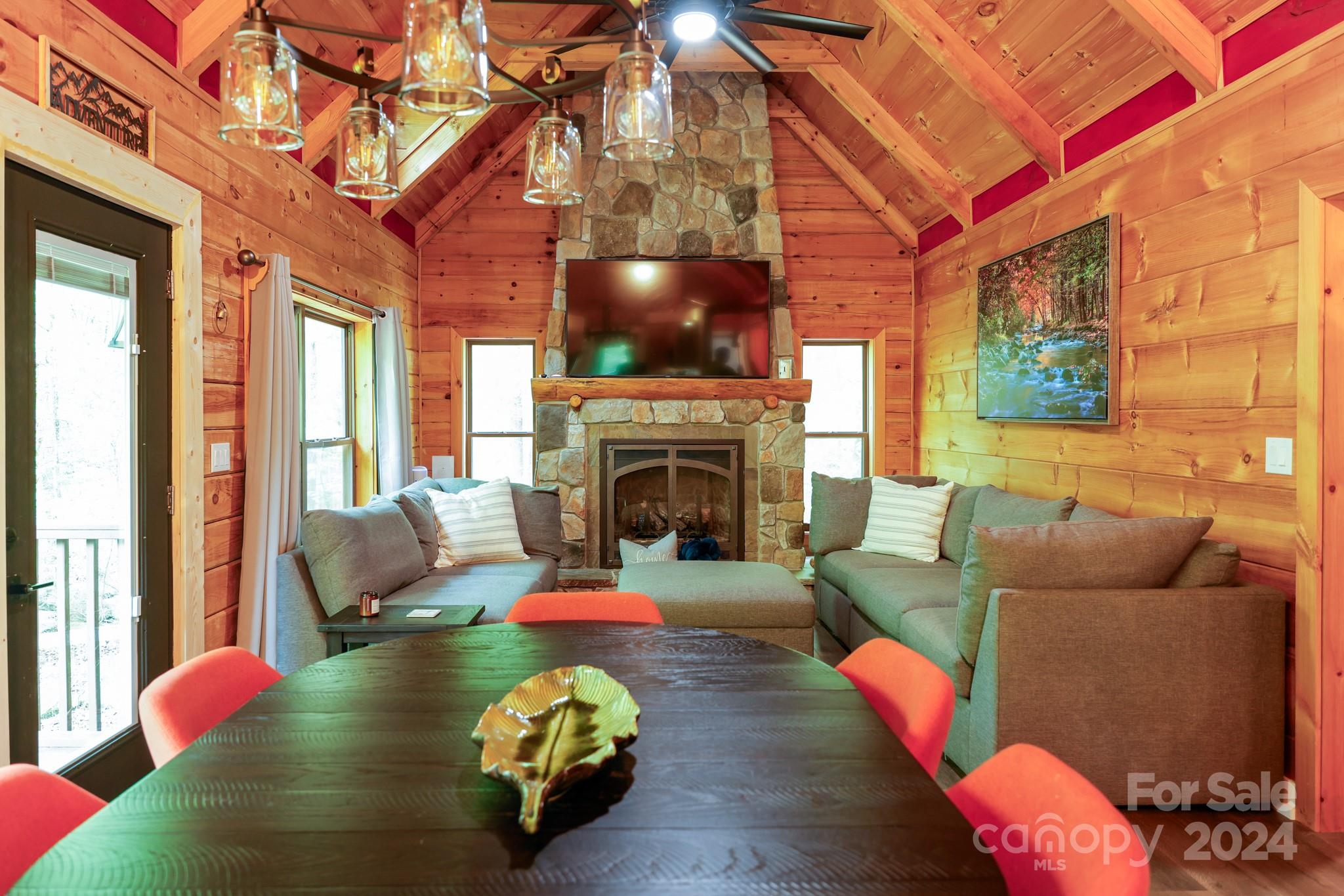 997 Proctor Road Lake Lure, NC 28746 - Photo 9 of 43 a living room with furniture and a fireplace