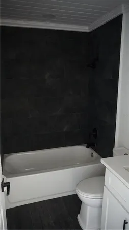 a bathroom with a bathtub and a toilet