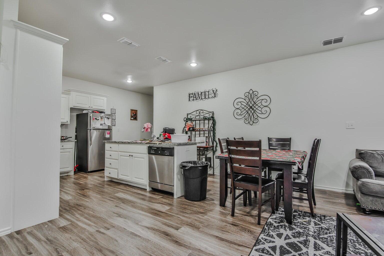 6908 20th Street Lubbock, TX 79407 - Photo 1 of 3 a view of a dining room with furniture and wooden floor