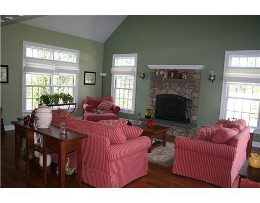 27 Laforge Road Darien, CT 06820 - Photo 9 of 20 a living room with furniture a fireplace and a large window
