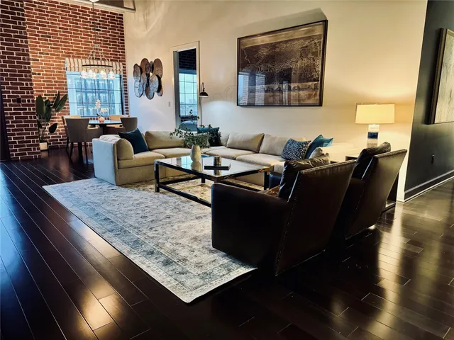 a living room with furniture rug and wooden floor