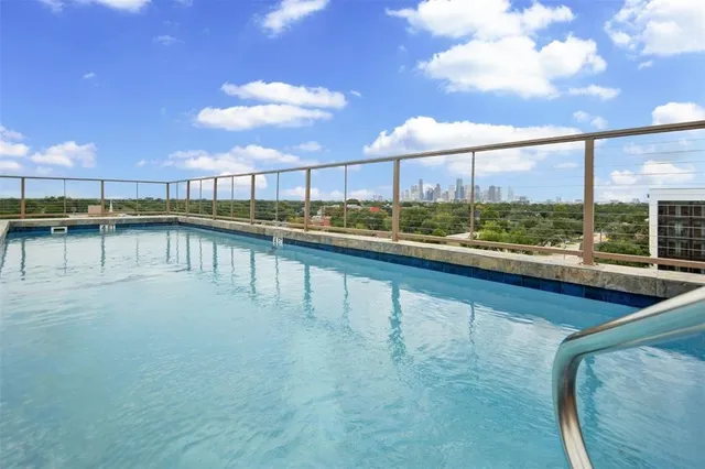 a view of a swimming pool and outdoor seating