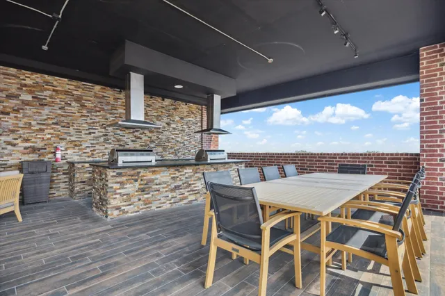 a view of a patio with table and chairs and wooden floor