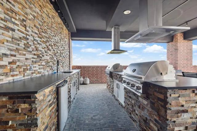 a kitchen with stainless steel appliances granite countertop a stove and a sink