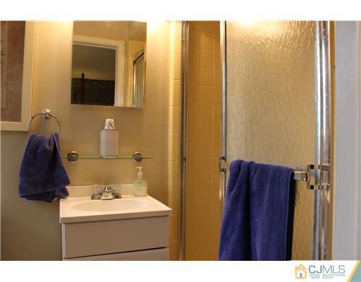 3 Devon Road Edison, NJ 08820 - Photo 13 of 17 a bathroom with a sink and a mirror