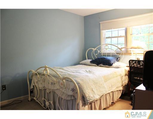 3 Devon Road Edison, NJ 08820 - Photo 15 of 17 a bedroom with a bed a dresser and a large window