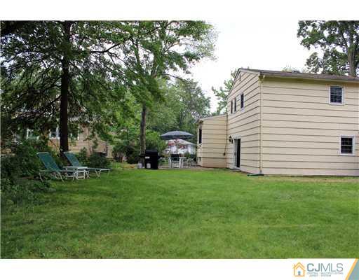 3 Devon Road Edison, NJ 08820 - Photo 17 of 17 a backyard of a house with table and chairs
