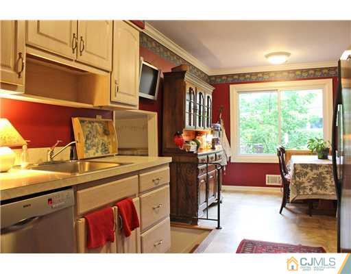 3 Devon Road Edison, NJ 08820 - Photo 6 of 17 a open kitchen with stainless steel appliances granite countertop a sink dishwasher and a dining table with garden view