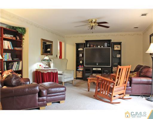 3 Devon Road Edison, NJ 08820 - Photo 9 of 17 a living room with furniture workspace and a flat screen tv