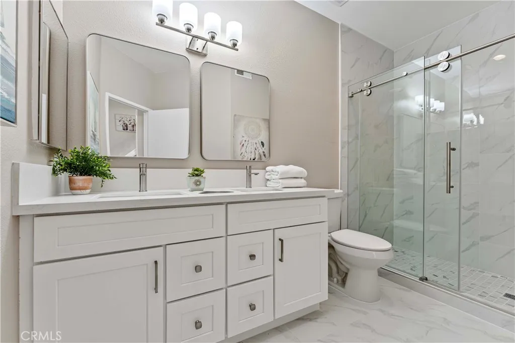 19431 Rue De Valore Lake Forest, CA 92610 - Photo 7 of 12 a bathroom with a sink toilet a mirror and shower