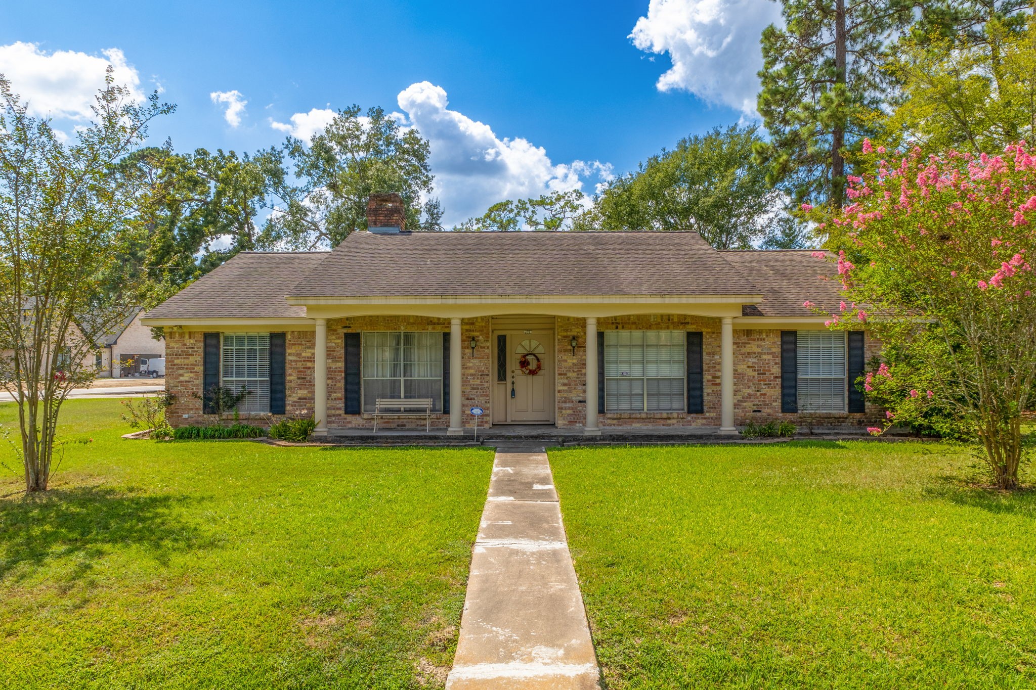 a view of a brick house with a yard