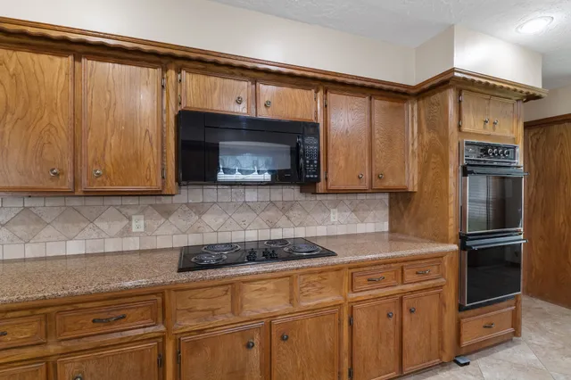 a view of kitchen with cabinets