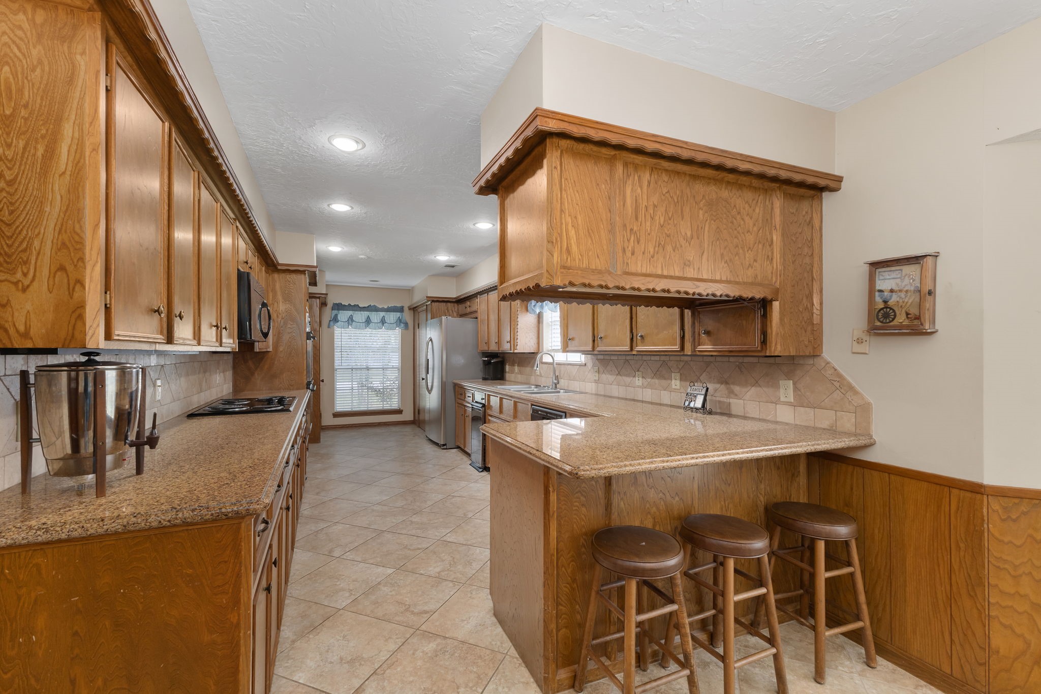 460 Dover Lane Spring, TX 77373 - Photo 15 of 47 a kitchen with kitchen island granite countertop a table and chairs in it
