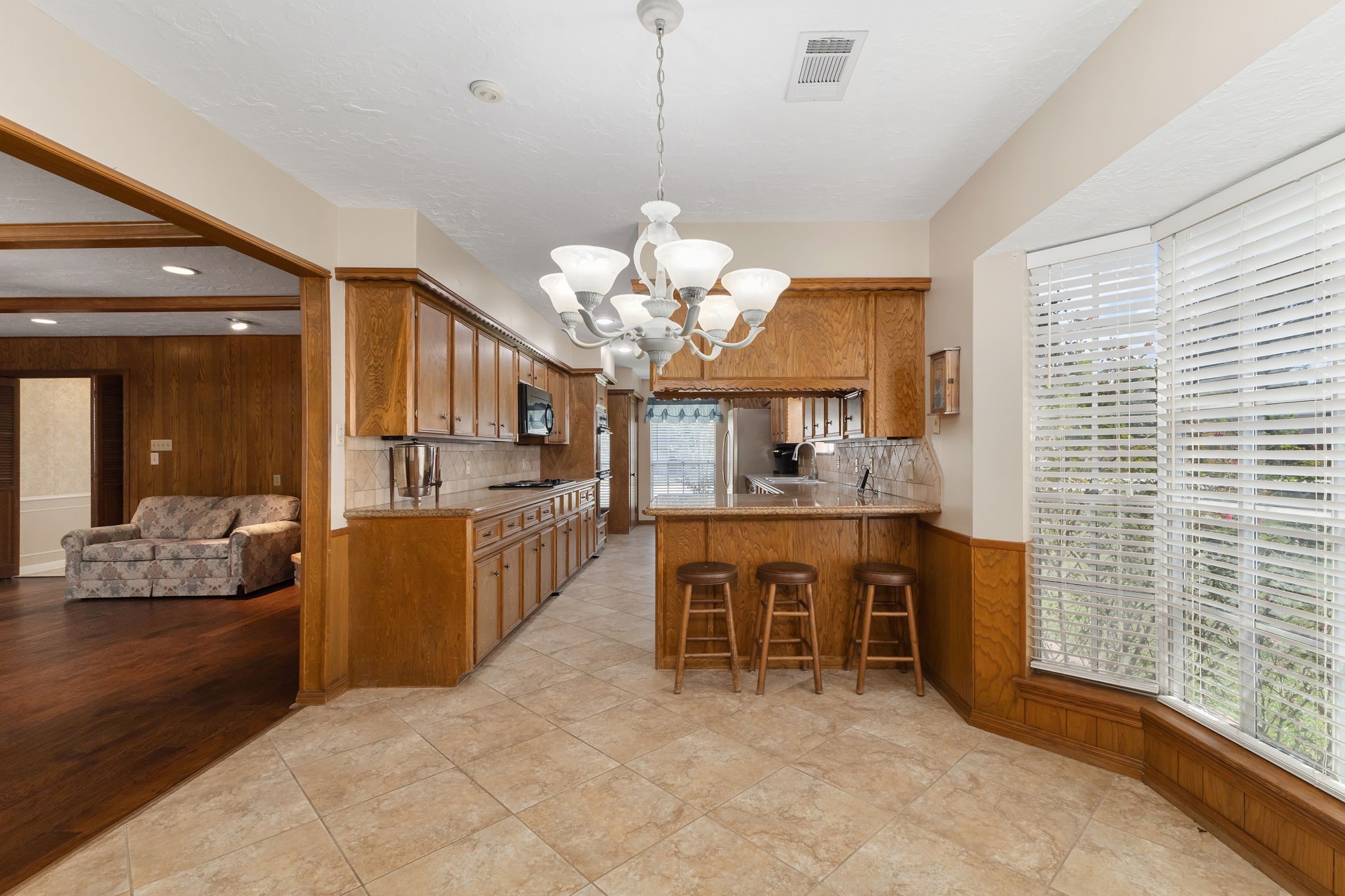 460 Dover Lane Spring, TX 77373 - Photo 16 of 47 a dining room with wooden floor a chandelier a wooden table and chairs