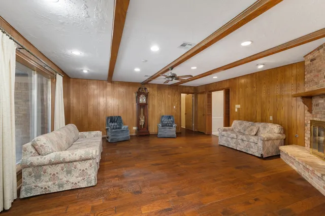 a view of an empty room with a chandelier fan