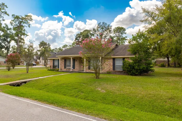 a view of a house with a yard and a garage