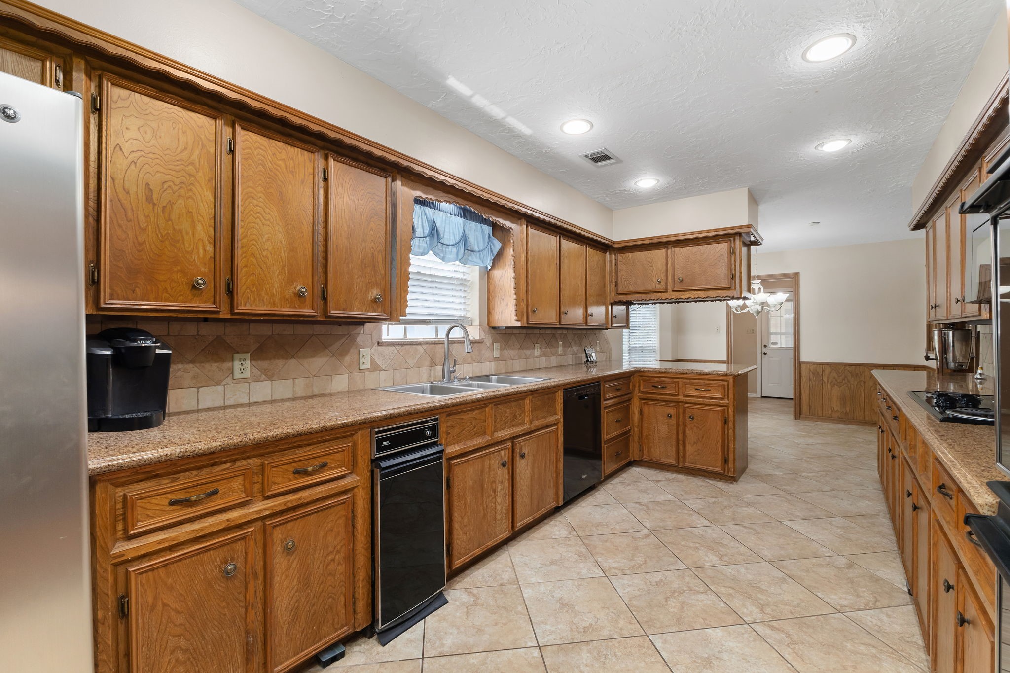 460 Dover Lane Spring, TX 77373 - Photo 9 of 47 a kitchen with stainless steel appliances granite countertop a stove a sink dishwasher and a refrigerator