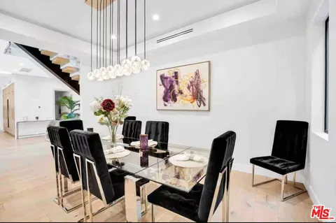 a view of a dining room with furniture and a chandelier