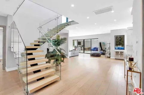 a living room with furniture and entryway