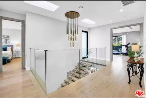a view of a hallway with furniture and a livingroom