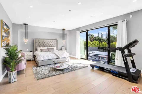 a bedroom with furniture and a large window