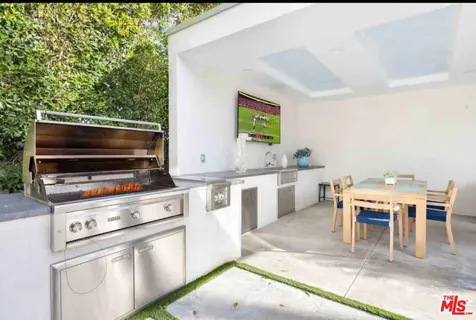 a view of backyard of house with seating area