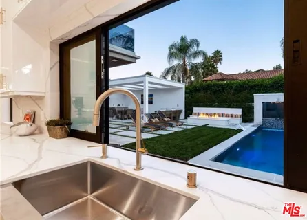 a view of a house with a sink and a mirror