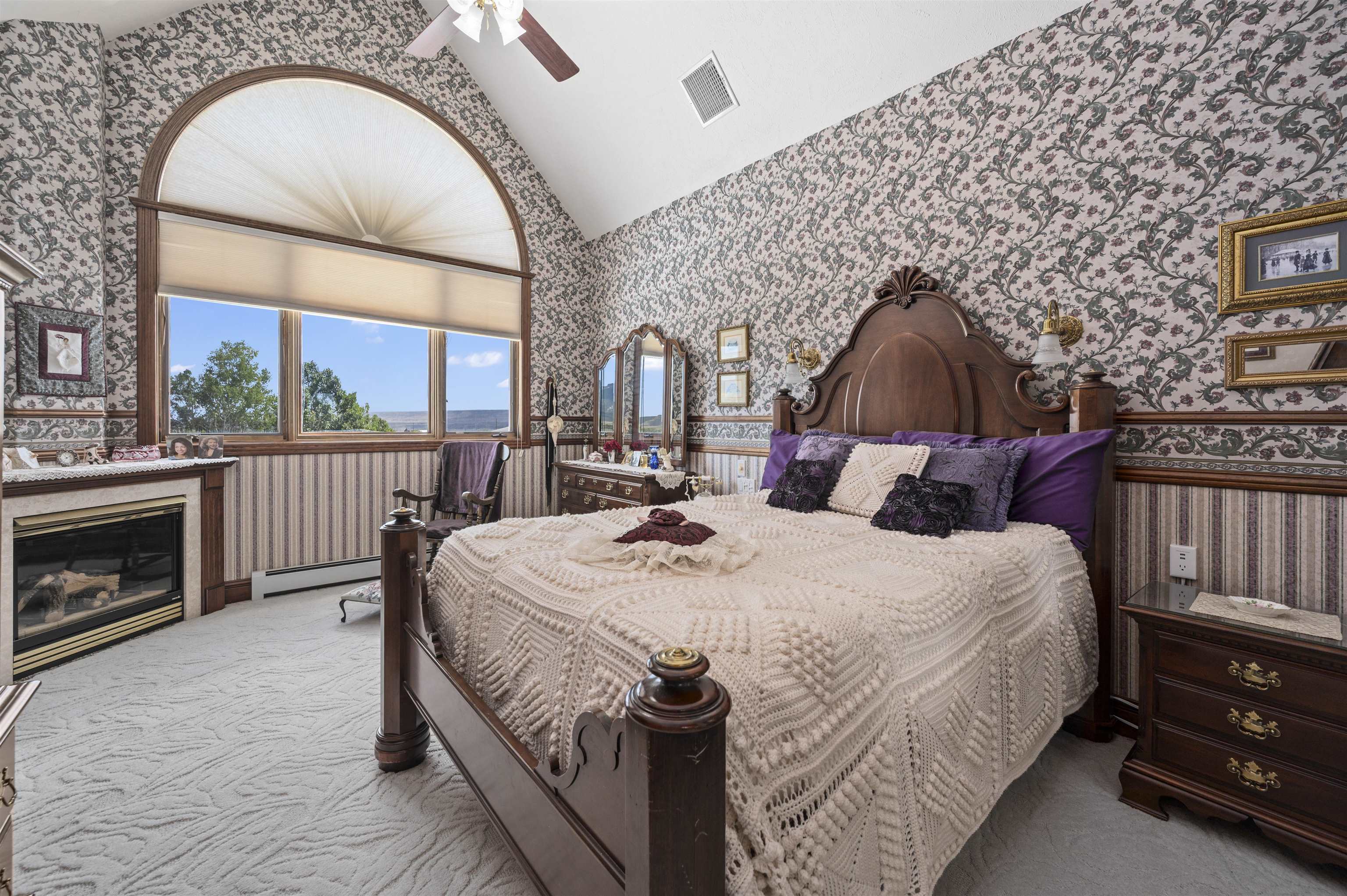 6800 Reeder Mesa Road Whitewater, CO 81527 - Photo 18 of 38 a bed sitting in a bedroom next to a balcony with a fireplace