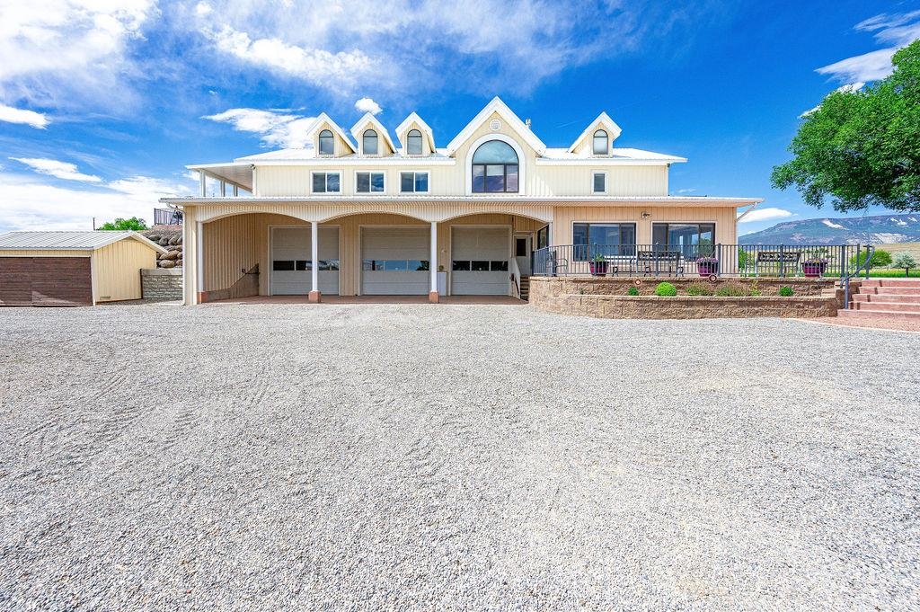 6800 Reeder Mesa Road Whitewater, CO 81527 - Photo 3 of 38 a front view of a house with a yard and garage