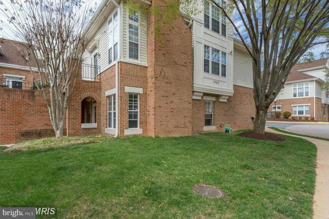 7037 Haycock Road, Unit A Falls Church, VA 22043 - Photo 9 of 10 a view of a brick house with a yard